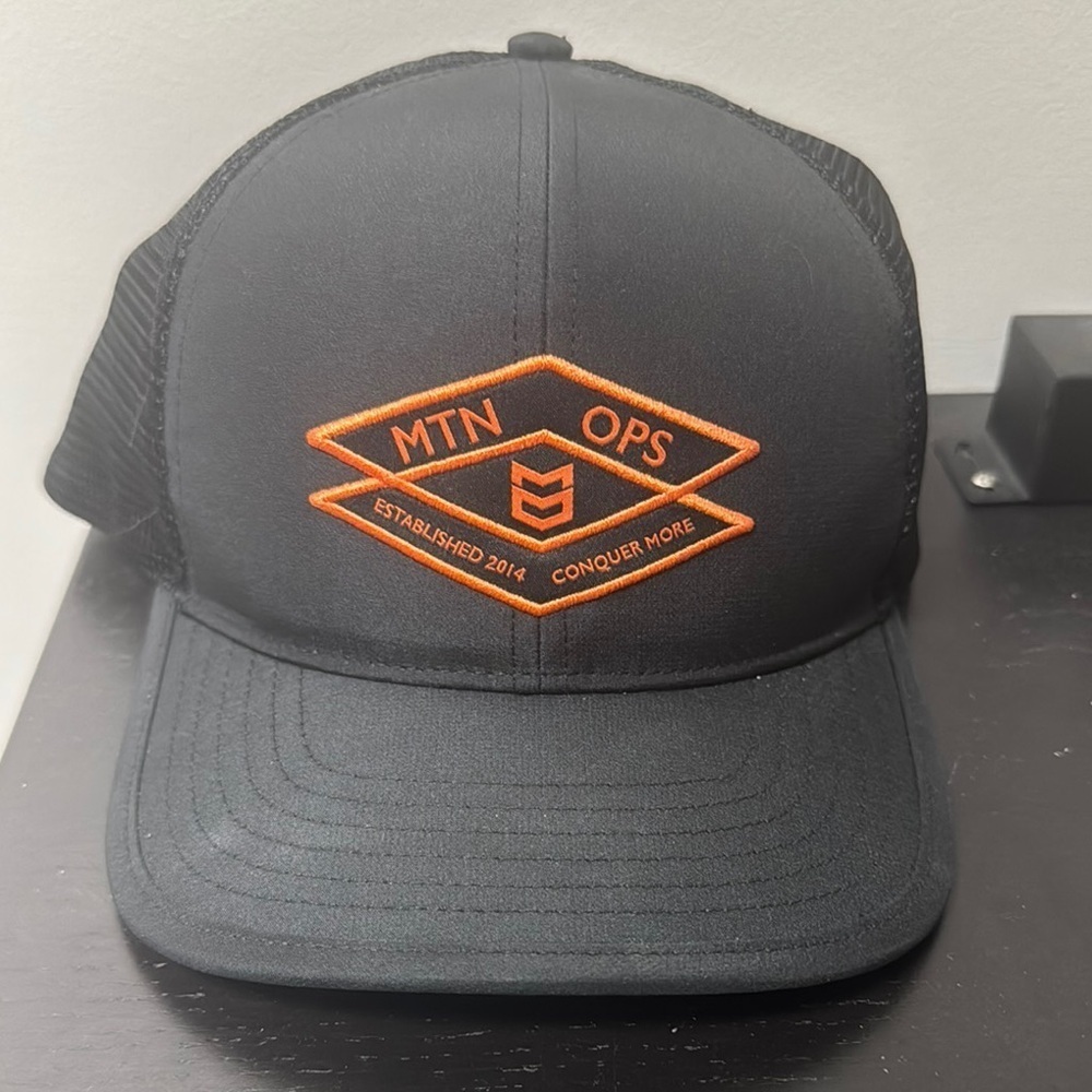 MTN OPS Black and Orange Trucker Hat